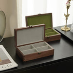 Emerald walnut jewelry box on wooden tabletop