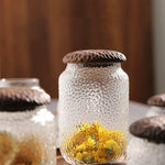 Haven Black Walnut Hammered Seal Glass Container holding tea leaves