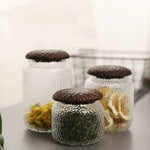 Haven Black Walnut Hammered Seal Glass Container on kitchen counter